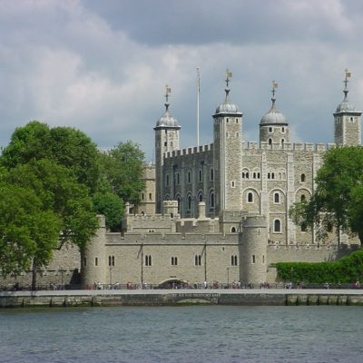 View of the historic Tower of London with a boat on the River Thames