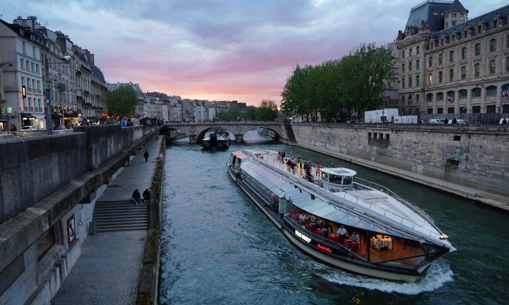 Seine River Cruises Evening cruise on the Seine River with a sunset backdrop